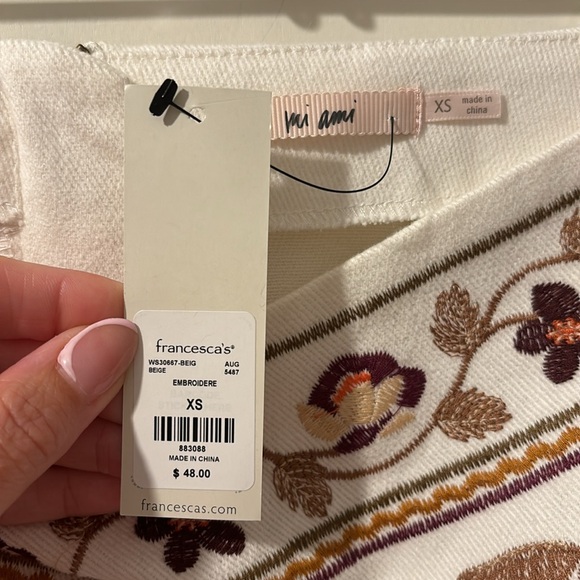 White denim mini skirt with embroidery on the front. Back center zipper. - Picture 2 of 2